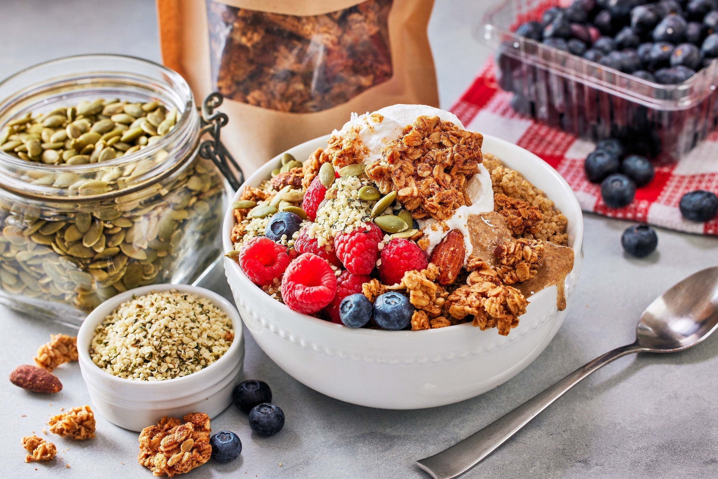Delicious protein-packed breakfast bowl with berries, Michele's Granola, and seeds for a nutritious start to the day.