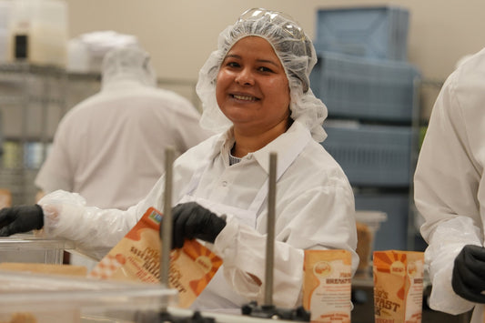 A smiling team member at the Micheles Granola bakery