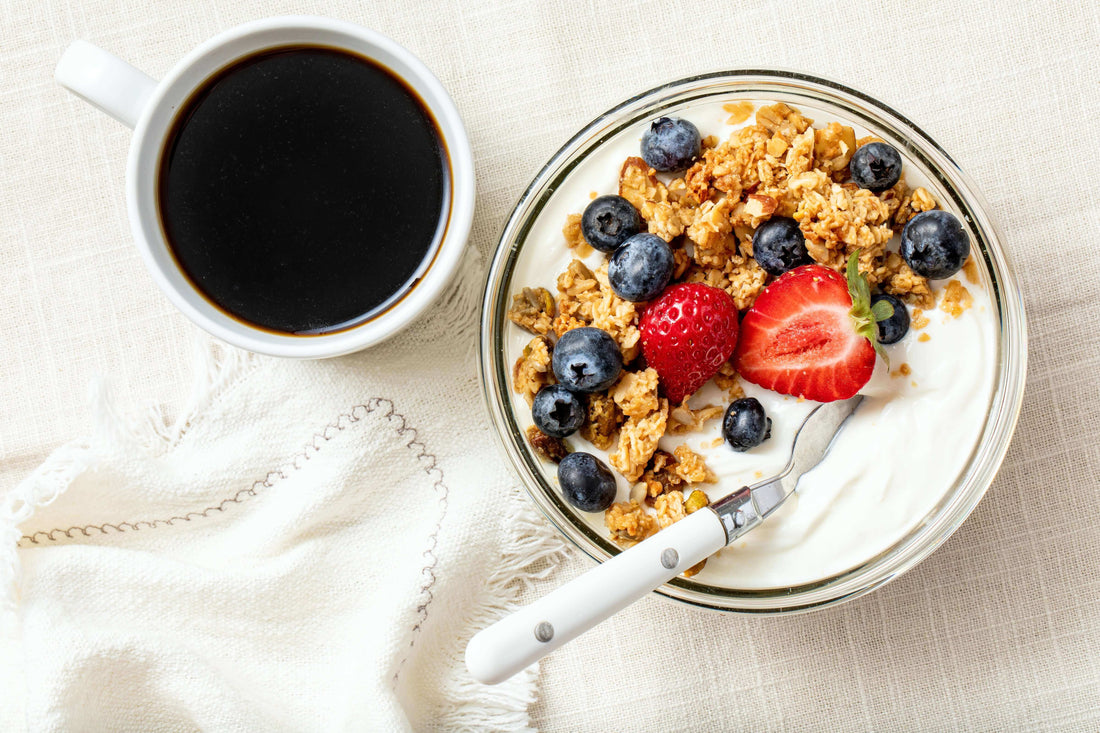 A bowl of yogurt topped with Michele's Granola, blueberries, and strawberries promoting a Stress-Free Morning.