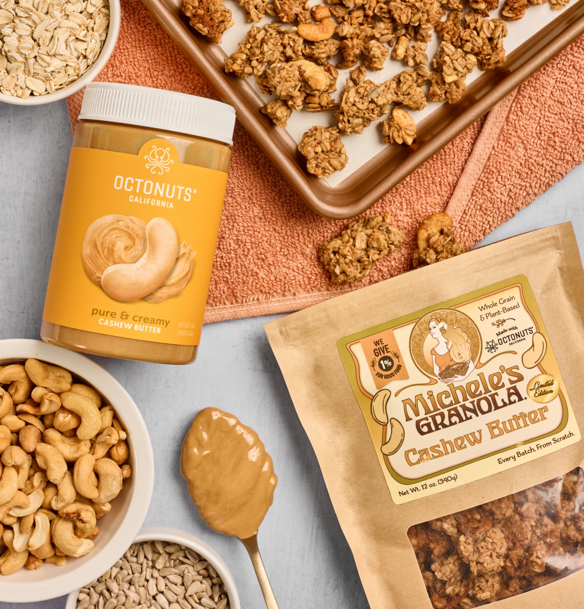 Michele's Granola Limited Edition Cashew Butter Granola with cashew butter jar and granola on a baking tray.