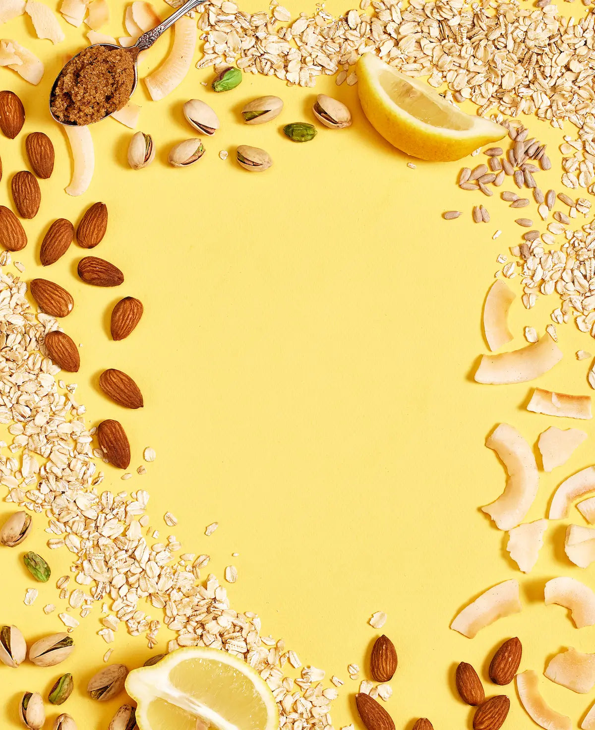 Michele's Granola nuts, seeds, and lemon slices arranged on a yellow background