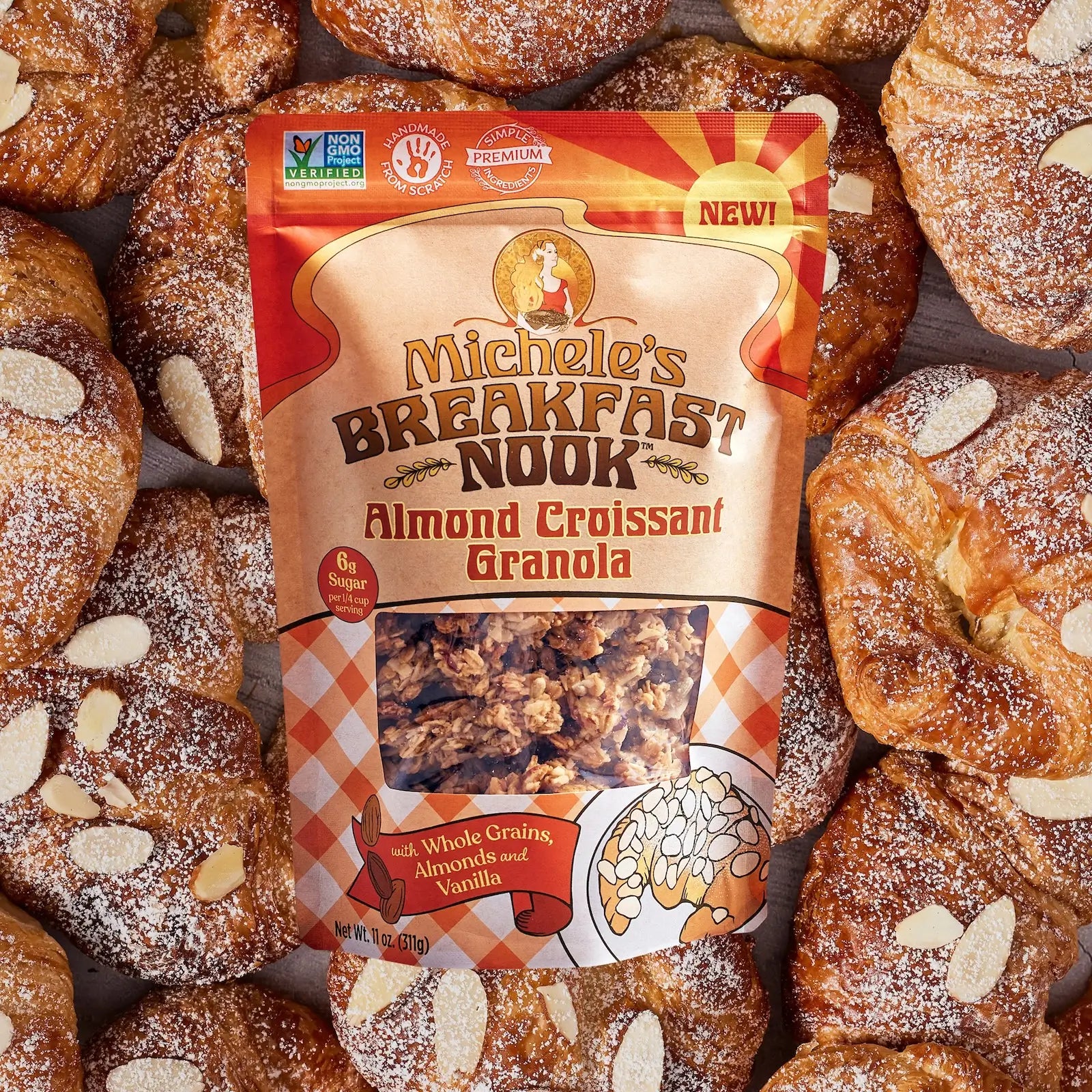 Michele's Breakfast Nook Almond Croissant Granola package surrounded by croissants